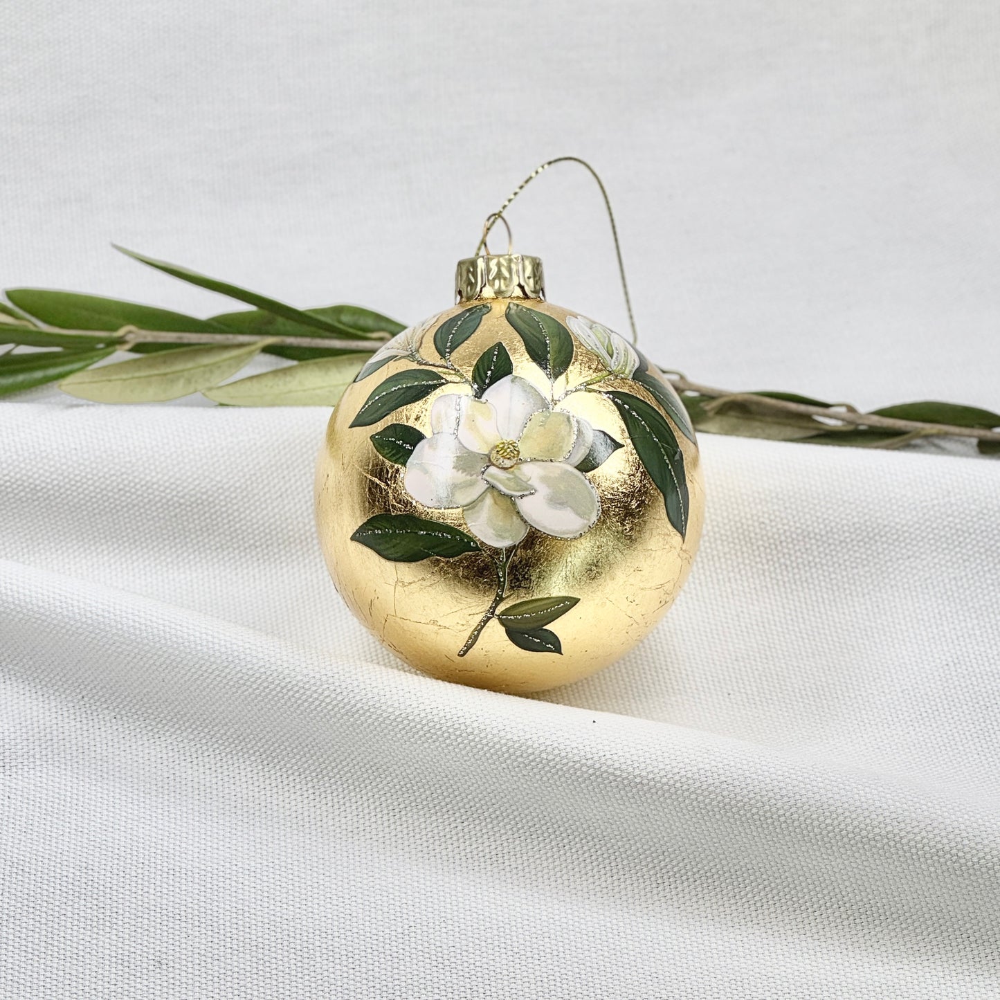 Golden Glass Ball Ornament With White Flowers